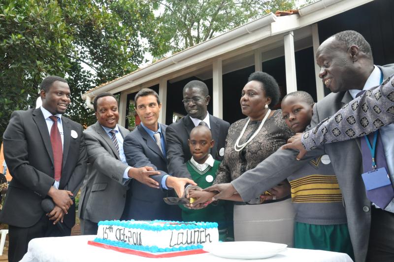 AfriChild partners cut a cake after the launch of the Centre
