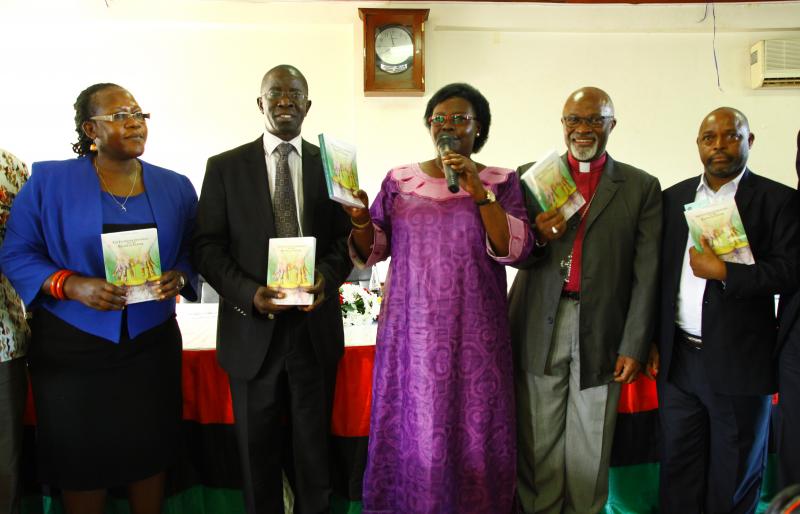 Hon. Grace Kwiyucwiny (C) launched the book