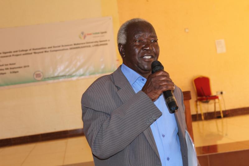 Rwot Yusuf Adek shares his views during the project impact workshop in Gulu