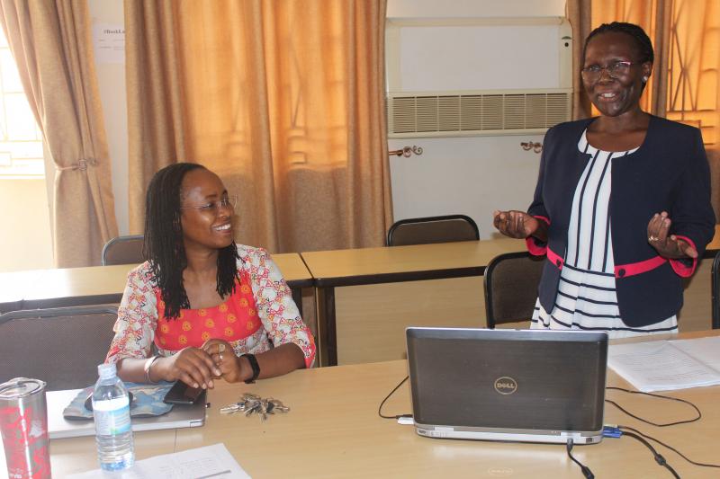 Dr Sylvia Nannyonga - Tamusuza (R) presents her research. Looking on is the Coordinator of the CHUSS Seminar Series, Dr Sarah Ssali