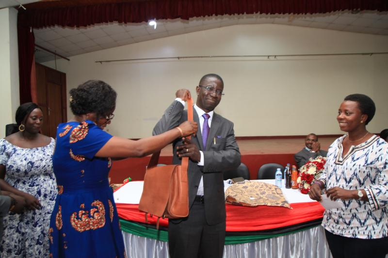 Prof. Kirumira shows off the gift from MISR