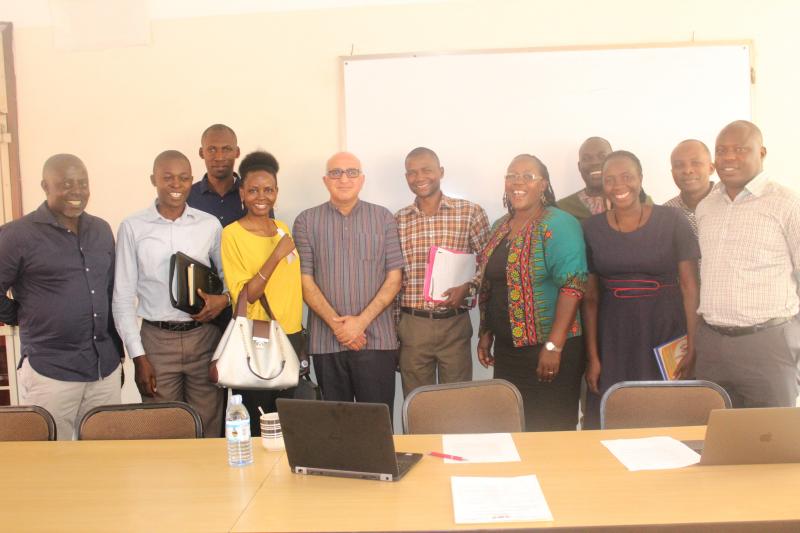 Dr Badat with the Principal of CHUSS, Dr Josephine Ahikire and the PhD students sponsored by the Foundation