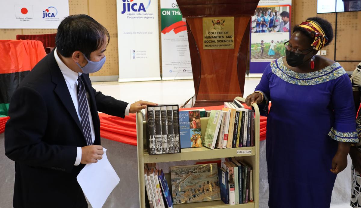 Fukuzawa Ichiro hands over books to Assoc. Prof. Josephine Ahikire