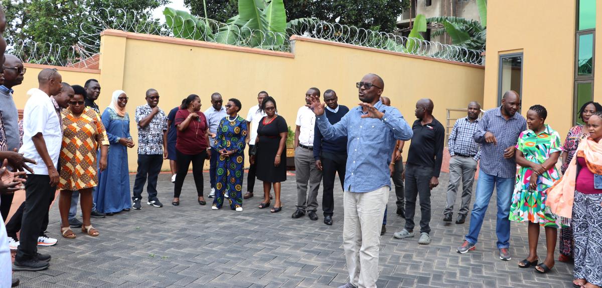 Kalema with staff otside the hotel on drills about leadership