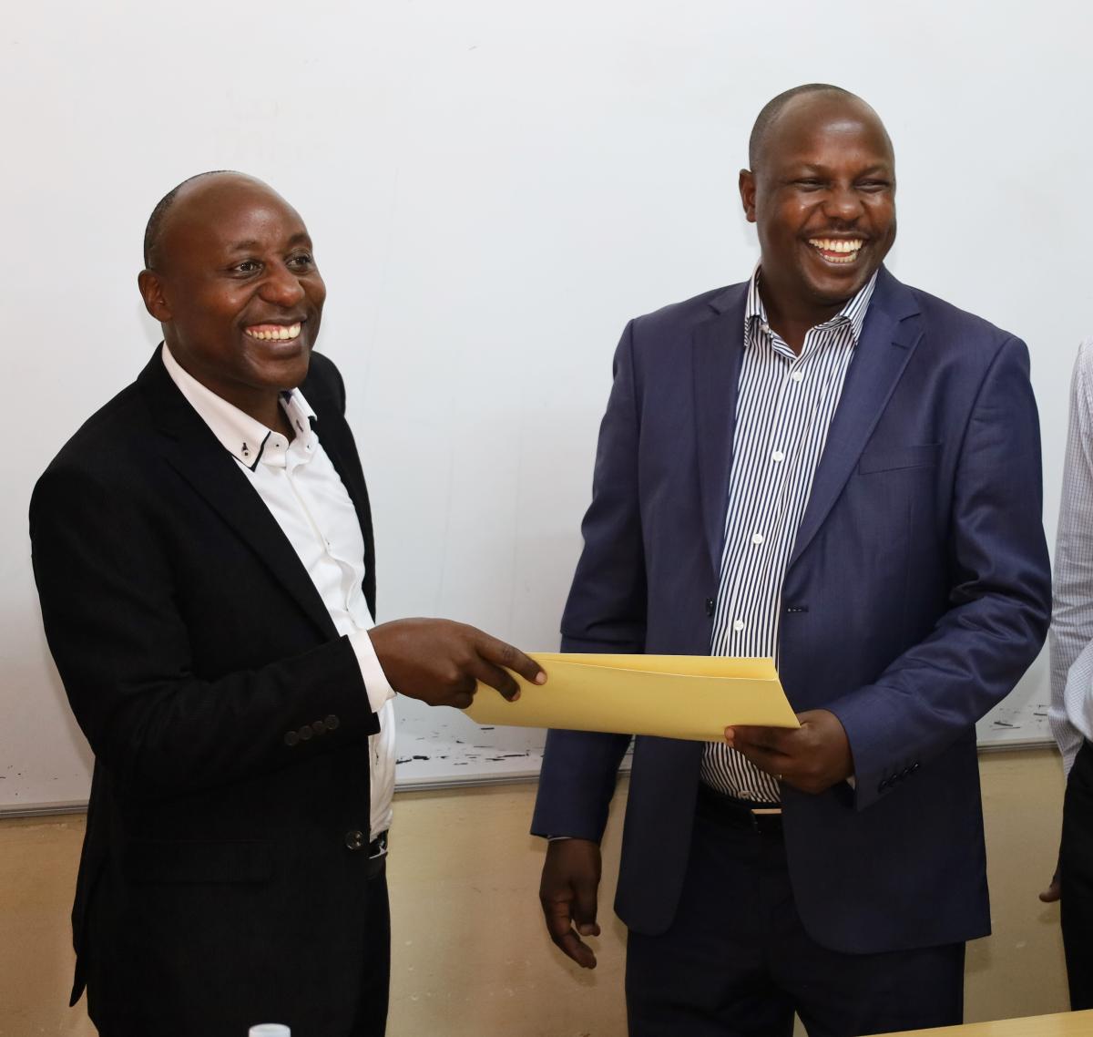 Prof. Eddy Walakira hands over to Dr. Denis Muhangi