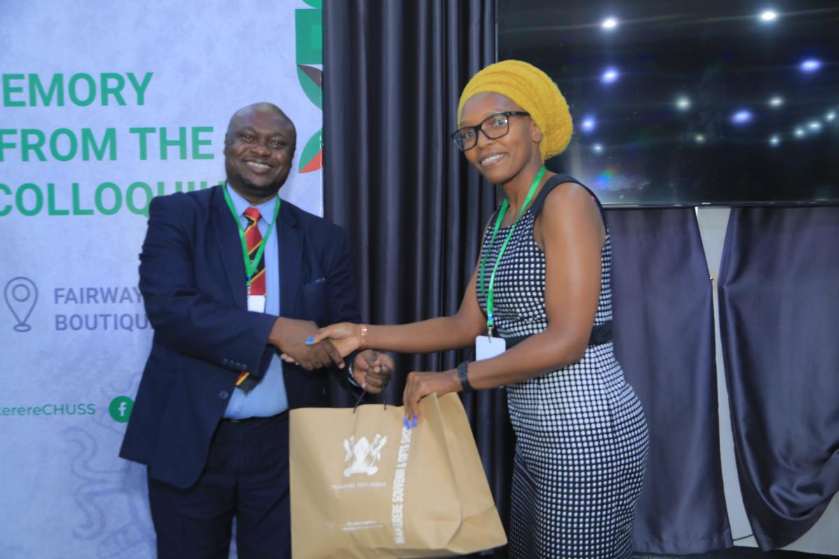 Prof. Grace Musila (R) receiving a gift  fron Assoc. Prof. Eric Awich