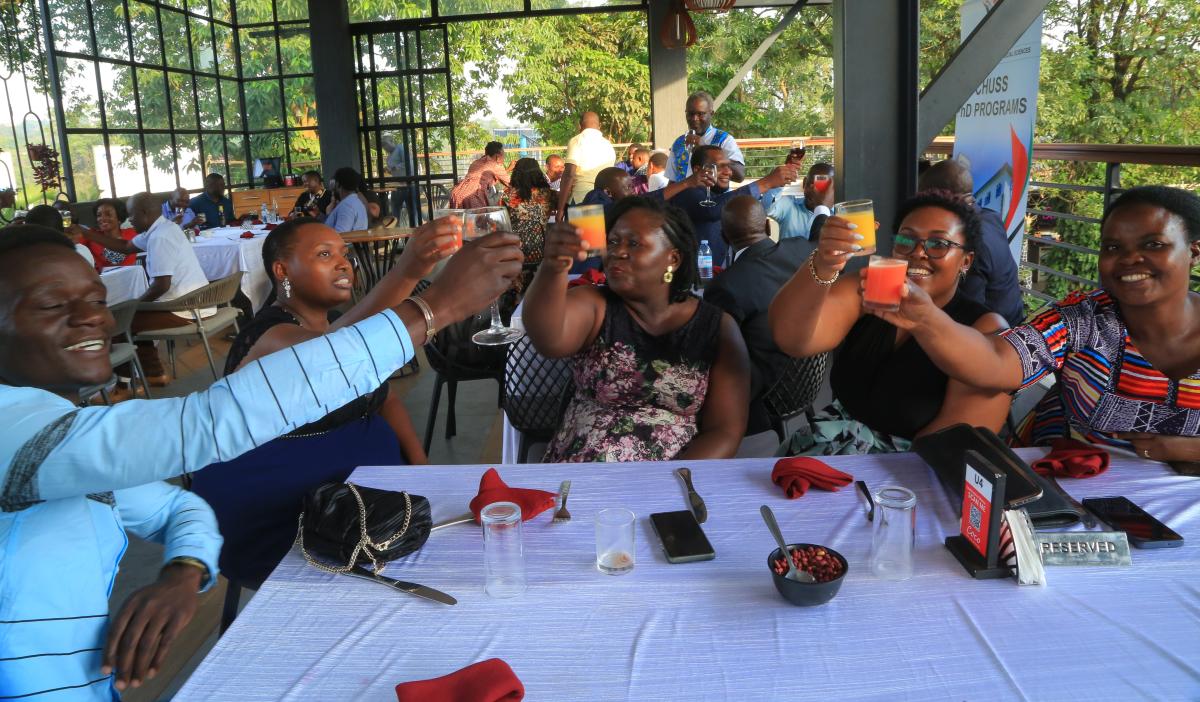 Staff and program beneficiaries tosting the drinks during the dinner