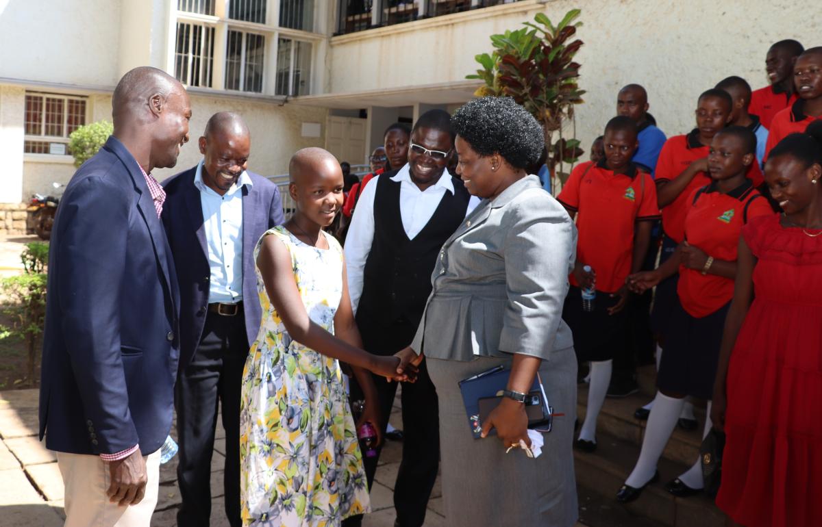 Teachers interact with the principal after the meeting