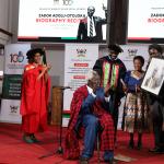  Assoc. Prof. Josephine Ahikire and Prof. Patric Mangeni unveil the potrait gift to Prof. Adolu