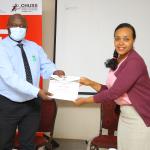 Dr. Eric Awich hands over the certificate to one of the PhD fellows after the training