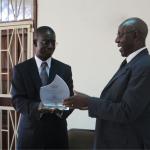 Prof Edward Kirumira (L) congragulates Prof Ndoleriire