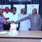 Staff cut cake in celebration of Dr Suzan Kiguli's achievement