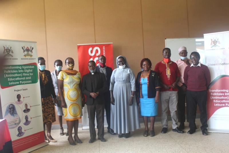 The project team - Prof. Sr. Dominica Dipio (C), Dr Susan Kiguli (2nd L), Dr Jimmy Spire Ssentongo (3rd R) and Mr. Isaac Tibasiima (R) with Dr Edith Natukunda (4th R), Ag. Dean, School of Languages, Literature and Communication at the event